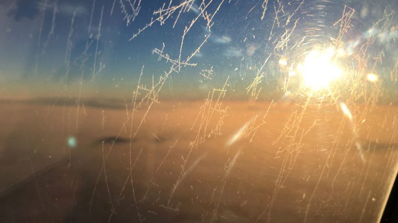 Flugzeugscheibe mit Eiskristallen während Flug - Moments of Travel
